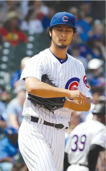  ??  ?? Cubs right- hander Yu Darvish reacts after allowing a two- run homer to the Rockies’ Nolan Arenado in the first inning. Darvish allowed five earned runs and seven hits in 4⅓ innings to remain winless. NAM Y. HUH/ AP