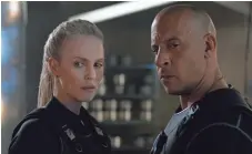  ?? UNIVERSAL PICTURES ?? New villain Cipher (Charlize Theron) and Dom (Vin Diesel) have a meeting of minds — and lips — in The Fate of the Furious.