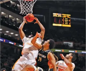  ?? TENNESSEE ATHLETICS PHOTO ?? Tennessee sophomore forward Tobe Awaka goes up for a rebound during Tuesday night’s 82-61 thumping of Wofford.