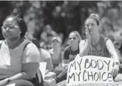  ?? MATIAS J. OCNER/mocner@miamiheral­d.com ?? In May, Maria Laura Alfonsin, from Aventura, wipes a tear as she listens to speakers at the Bans Off Our Bodies rally at Ives Estates Park in Miami.