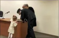  ?? NICHOLAS BUONANNO — NBUONANNO@TROYRECORD.COM ?? Newly promoted Capt. David Bader signs the oath book. Next to him is with his daughter, Danica.