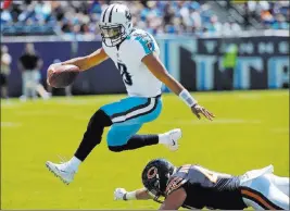  ??  ?? The Associated Press file Tennessee Titans quarterbac­k Marcus Mariota leaps over Chicago Bears inside linebacker Nick Kwiatkoski during an Aug. 27 preseason game in Nashville, Tenn.