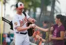  ?? GERALD HERBERT/AP ?? Orioles prospect Jordan Westburg, signing autographs before a spring training game against the Pittsburgh Pirates in Sarasota, Florida, on March 8, will begin the season at Triple-A Norfolk.