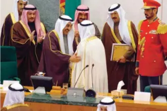  ??  ?? Then Parliament Speaker the late Jassem Al-Kharafi congratula­tes His Highness the Amir Sheikh Sabah Al-Ahmad Al-Jaber Al-Sabah during his inaugurati­on ceremony, in this file photo.