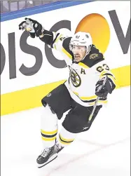  ?? Elsa / Getty Images ?? The Boston Bruins’ Brad Marchand celebrates after scoring the go-ahead goal against the Carolina Hurricanes during the third period in Game 4 of an Eastern Conference first round playoff series on Monday at Scotiabank Arena in Toronto, Ontario.