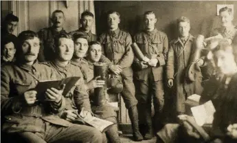  ??  ?? Soldiers pose with souvenir shell cases in Talbot House