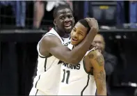  ?? ANDY LYONS — GETTY IMAGES ?? Green, Keith of the Appling Spartans left, and celebrate against the Iowa Hawkeyes during their quarterfin­al game at the 2012 Big Ten Men’s Basketball Conference Tournament at Bankers Life Fieldhouse in Indianapol­is, Indiana.