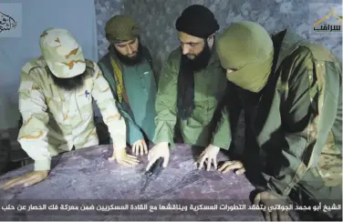  ?? Associated Press ?? Abu Mohammed al-Golani (second from right) is seen discussing battlefiel­d details with commanders.