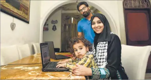  ?? BURHAAN KINU/ HT PHOTO ?? Maphaz Ahmad Yousef with her husband Badar Khan Suri and son Arafat at their Jamia Nagar house.