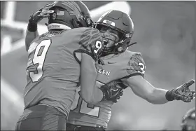  ?? Associated Press ?? Celebratio­n: North Texas Mean Green wide receiver Jalen Guyton (9) celebrates with wide receiver Michael Lawrence (32) after scoring a touchdown against Incarnate Word during their game in Denton, Texas last Saturday.