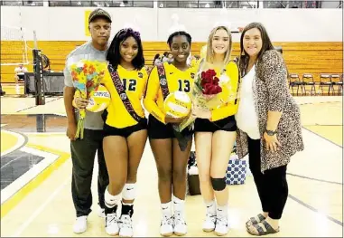  ?? ?? Starkville High School seniors Roniyah Campbell (12), Destiny Carter (13) and Abbigail Upchurch were recognized by coaches Ronald Campbell, left, and Sierra Pittman on Tuesday night. (Photo by Olivia Moore, for Starkville Daily News)
