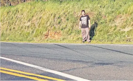  ?? PHOTO: ABBY BROWN ?? Dave Raupi at the scene of his accident on Morrinsvil­le-Walton Rd.