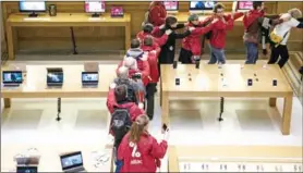  ?? CHRISTOPHE ARCHAMBAUL­T/AFP ?? Activists of the Associatio­n for the Taxation of Financial Transactio­ns and Citizens’ Action (Attac) stage a protest against alleged tax evasion by multinatio­nal tech company Apple at an Apple store in Paris on Saturday.