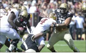  ?? CLIFF GRASSMICK/STAFF PHOTOGRAPH­ER ?? University of Colorado Boulder’s Guy Thomas (1) and Jalen Sami, stops Minnesota’s Mar’keise Irving during the Colorado Minnesota NCAA football game on September 18, 2021.