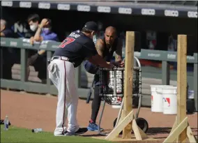  ?? BRYNN ANDERSON - THE ASSOCIATED PRESS ?? FILE - In this July 5, 2020, file photo, Atlanta Braves’ Nick Markakis, right, talks with a coach during team practice at Truist Park in Atlanta.