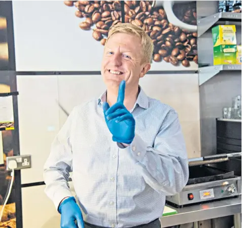  ?? ?? Oliver Dowden on the election trail in Yummy’s café in Sutton. The Tory party chairman said people were fed up with the distractio­n of partygate and were more concerned about how often bins were collected