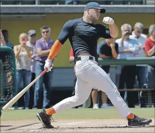  ?? AP PHOTO ?? Former NFL quarterbac­k Tim Tebow hits during batting practice for baseball scouts and the media at a showcase Tuesday in Los Angeles.