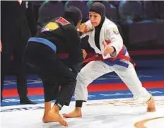  ?? Abdul Rahman/Gulf News ?? Mahra Al Hanaei, (white jersey) and Khuloud Al Nuaimi seen in action in the 52kg category during the Championsh­ip yesterday.