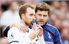  ??  ?? File photo of Tottenham’s Christian Eriksen with manager Pochettino before coming on as a substitute during a Premier League match. — Reuters photo