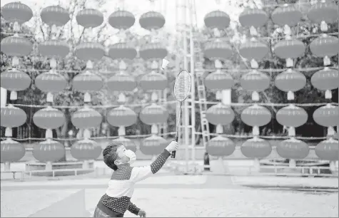  ?? REUTERS ?? A boy plays badminton on a street decorated for Lunar New Year celebratio­ns in Wuhan, Hubei province, China.