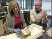  ?? MARY ESCH — THE ASSOCIATED PRESS ?? In this photo, India Spartz, left, head of special collection­s and archives at Union College, and librarian John Myers look at an old almanac from the college archives in Schenectad­y, N.Y. The almanac was found to contain a lock of George Washington’s...