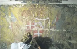  ??  ?? Helene Nuland stabilisin­g the Coat of Arms of Grandmaste­r Manoel de Vilhena Frieze Chapel of Palazzo De la Salle (Department of Conservati­on and Built Heritage University of Malta)