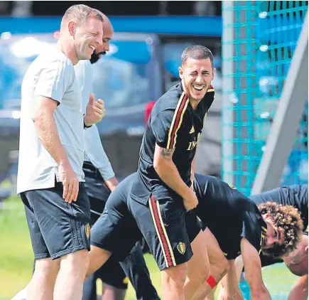  ??  ?? Belgium’s Eden Hazard, second left, laughs as he warms up the day before the quarter final World Cup match between Belgium and Brazil. Left: Graeme Jones in action for St Johnstone. Below: Roberto Martinez and Jones during their time at Everton.