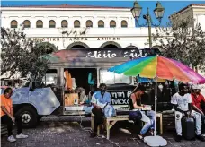  ?? AFP ?? Library vans in Athens offer refugees a chance to learn, or simply to use fiction as a temporary escape from reality