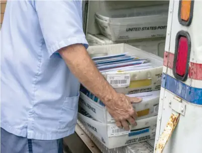  ?? AP FILES ?? A postal worker loads mail in Virginia. Postmaster General Louis DeJoy continues to weaken the U.S. Postal Service — for President Donald Trump’s political benefit.