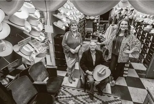  ?? William Luther / Staff photograph­er ?? Paris Hatters owners Myrna and Abe Cortez, and Alexandra Cortez Sledge say sales at the San Antonio institutio­n are picking up.