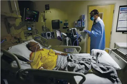  ?? NHAT V. MEYER — STAFF PHOTOGRAPH­ER ?? Dr. Kashif Hassan talks with Covid-19patient Juan Flores on Monday in the intensive care unit at Regional Medical Center in San Jose. Flores had been taking baby steps toward recovery until Thursday, when his oxygen levels plummeted despite advances in treating COVID-19.