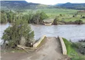  ?? AP Photo/Rick Bowmer ?? A washed-out bridge shown along the Yellowston­e River on Wednesday near Gardiner, Mont. Historic floodwater­s that raged through Yellowston­e National Park may have permanentl­y altered the course of a popular fishing river and left the sweeping landscape forever changed.