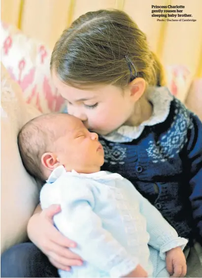  ?? Photo / Duchess of Cambridge ?? Princess Charlotte gently rouses her sleeping baby brother.