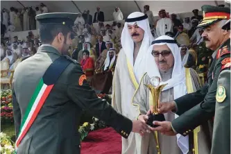  ??  ?? KUWAIT: His Highness the Amir Sheikh Sabah Al-Ahmad Al-Jaber Al-Sabah honors a graduate as Deputy Prime Minister and Minister of Defense Sheikh Mohammad Al-Khaled Al-Hamad Al-Sabah and Army Chief of Staff Lieutenant General Mohammad Al-Khudher look on....