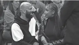  ?? PAUL BEATY/AP ?? Rapper and actor Common, left, and singer and actress Jennifer Hudson talk during an NBA basketball game between the Chicago Bulls and the Philadelph­ia 76ers in Chicago in December 2023.