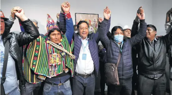  ?? JUAN KARITA/AP ?? Disputa. Luis Arce (ao centro) comemora ao lado do vice, David Choquehuan­ca (de bolsa), a vitória no primeiro turno na eleição realizada no domingo
