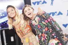  ??  ?? Paris Jackson and Caroline D’Amore pose in the press room during the 2017 MTV Video Music Awards at The Forum on Aug 27 in Inglewood, California.