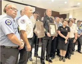  ?? JERRY FALLSTROM/ORLANDO SENTINEL ?? Clermont Fire Chief Carle Bishop, who is retiring after 49 years with the department, is honored Tuesday at a Clermont City Council meeting.