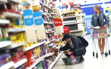  ??  ?? Shoppers browse aisles in a supermarke­t in London, Britain. — Reuters photo