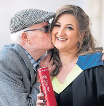  ?? ?? GRANDAD’S KISS: William Slamon congratula­tes granddaugh­ter Amie Smith, from Ardler, who graduated in Psychology and Counsellin­g at a previous Abertay ceremony.