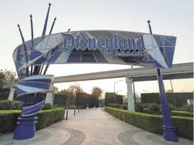 ?? MARIO TAMA/GETTY IMAGES ?? Disneyland stands empty last month in Anaheim, California. The theme park’s president calls new state guidelines “arbitrary.”