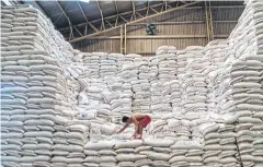  ??  ?? VALUABLE STOCK: A National Food Authority rice warehouse in Quezon City, Philippine­s. Soaring prices for rice is putting the squeeze on Rodrigo Duterte’s government.