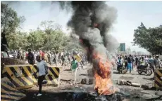  ?? — AFP ?? Opposition supporters block streets and burn tyres during a protest in Kisumu, Kenya, on Wednesday.