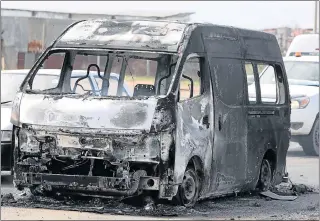  ?? Picture: BRIAN WITBOOI ?? BURNT OUT: Vehicles were set alight during protest action in Westville in Port Elizabeth’s northern areas in August