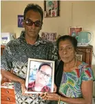  ??  ?? Sudesh Singh and his mother Parvati showing Vinay Singh’s photo inside their Vunivau home in Labasa on July 28,2020.. Photo: Shratika Naidu