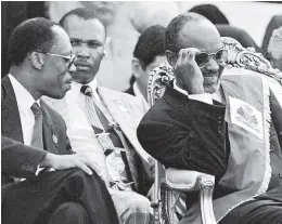  ?? AP ?? Former Haitian President Jean-Bertrand Aristide (left) jokes with newly sworn-in Haitian President René Préval during inaugurati­on ceremonies at the National Palace in Port-au-Prince, Haiti on February 7, 1996. Preval, the only democratic­ally elected president to win and complete two terms, took a hard line on the gangs, giving them the choice to “disarm or be killed”.