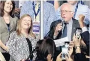  ?? DREW ANGERER/GETTY IMAGES ?? Sen. Bernie Sanders, with the Vermont delegation and his wife, Jane O’Meara Sanders, votes during the roll call Tuesday in Philadelph­ia. He offered an enthusiast­ic endorsemen­t of Clinton and urged his backers to end their rowdy resistance to her...