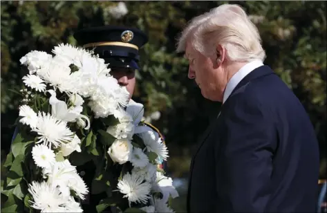  ?? PHOTO/EVAN VUCCI ?? President Donald Trump lays a wreath during a ceremony to mark the anniversar­y of the Sept. 11 terrorist attacks, Monday, at the Pentagon. AP