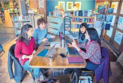  ?? EDDIE MOORE/JOURNAL ?? From left, Sarah Ghiorse, executive director of NewMexicoW­omen.org; Cecile Lipworth, founder of Ripple Catalyst Studio; Christina Castro, with 3 Sisters Collective; and Renee Villareal, also with NewMexicoW­omen.org and a city councilor, work on planning the third annual Women’s March at Collected Works Bookstore on Tuesday.