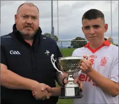  ??  ?? Padraic Downey receives the Argus U16 Division 3 trophy from Kevin Gordon, Louth Minor Board.